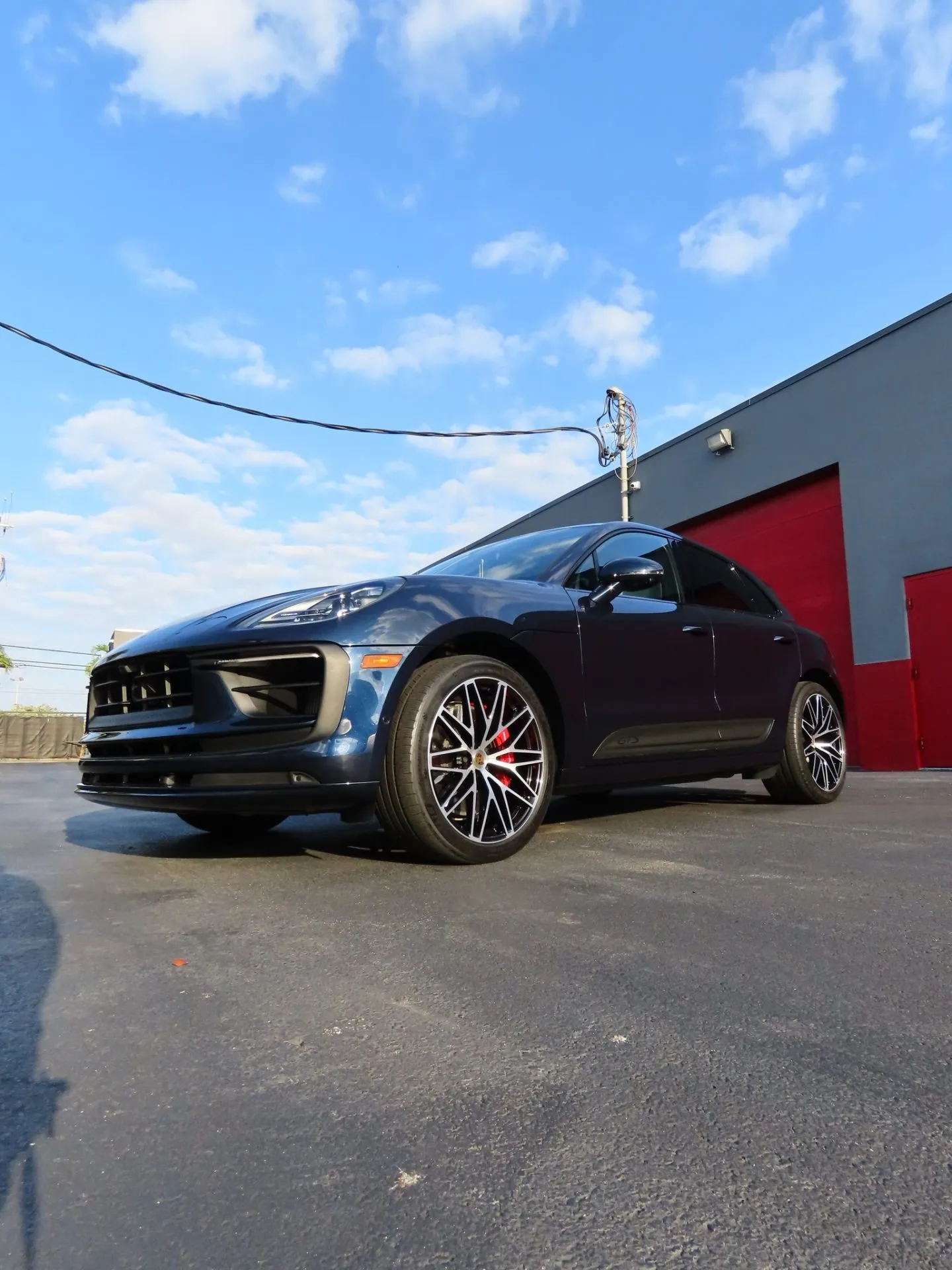 Dark blue Porsche Macan parked outside the Advanced Detailing Sofla studio