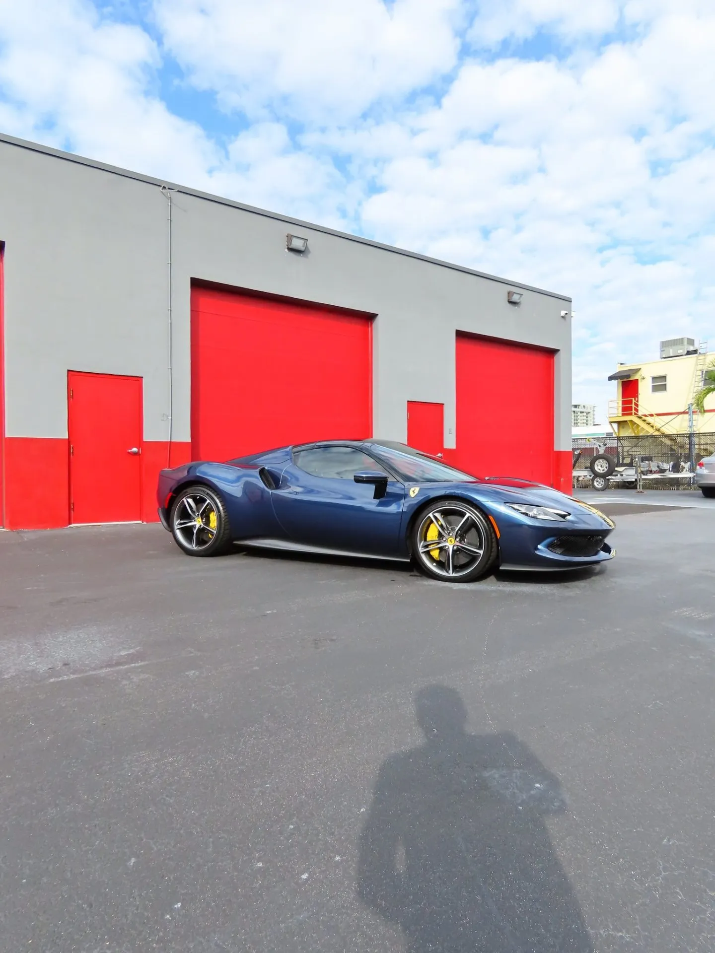 Dark blue Ferrari 296 GTB parked outside the Advanced Detailing Sofla studio
